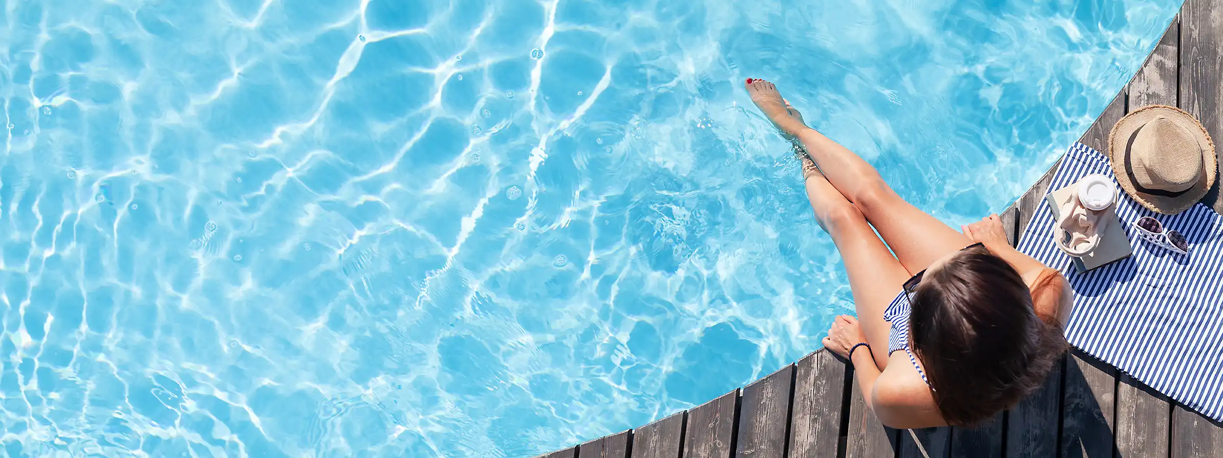 photo of a clean backyard pool with woman in Sun hat