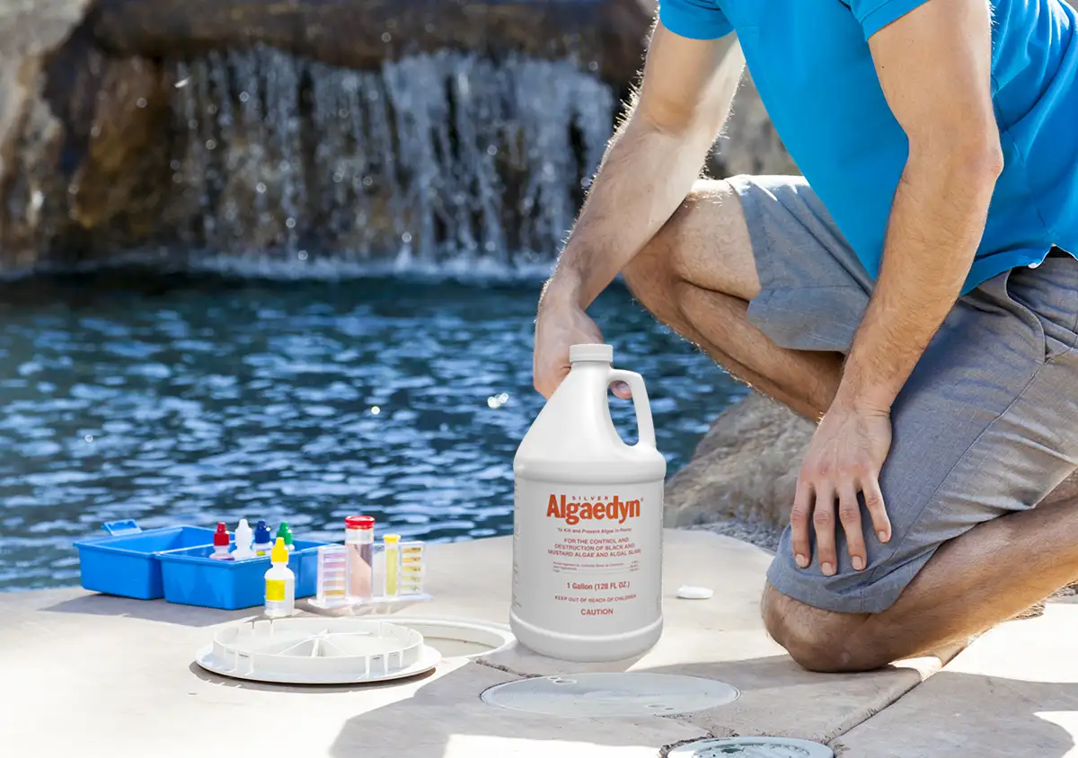 Pool Technician using Silver Algaedyn in a commercial setting
