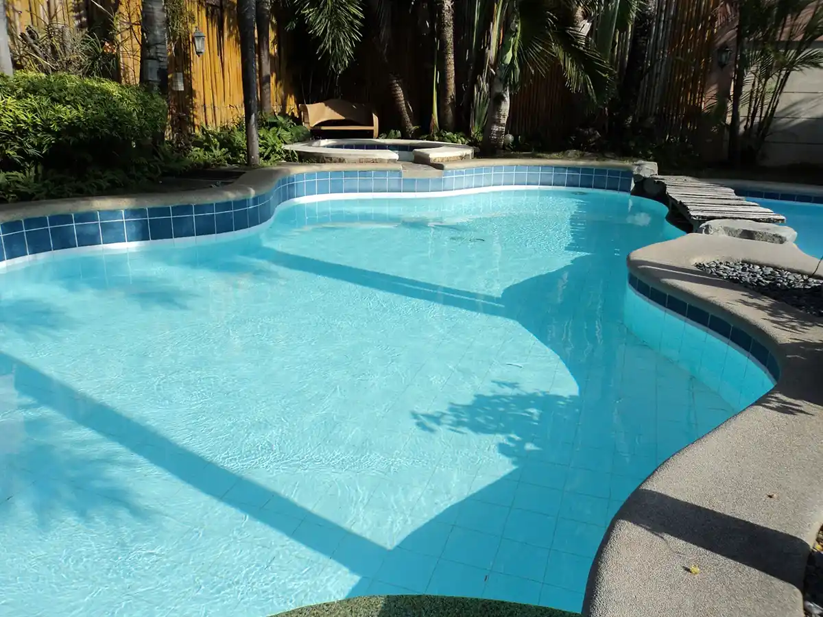 wavy edged, in-ground pool with clean water