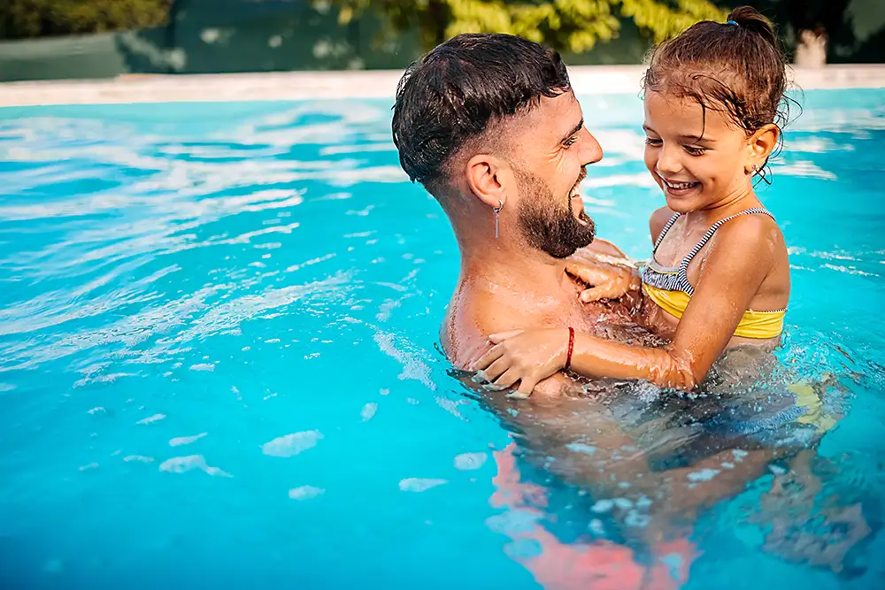 pool of a Father and his daughter in a clean pool